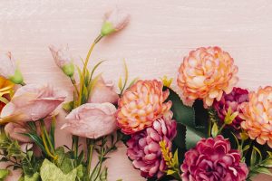 colorful flowers on pink wooden background